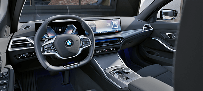 Modernes Cockpit eines BMW mit digitalem Curved Display und hochwertiger Innenausstattung in dunklem Design.